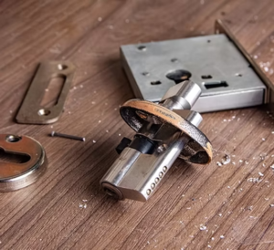 Disassembled mortise lock and cylinder on a workbench