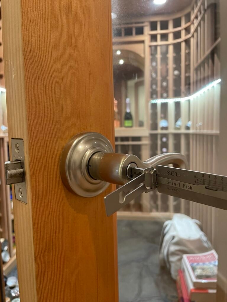 Lishi tool in the keyed lever of an open door after a Belle Terre lockout opening