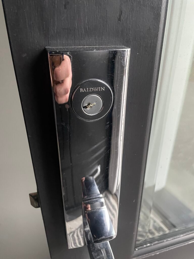 Broken key lodged in a Baldwin lock during a Cedarhurst Avenue service call in Selden
