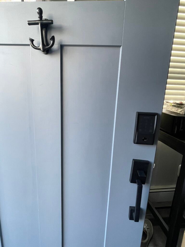 Black keypad lock and matching handleset installed on a Grove Street front door in Sayville