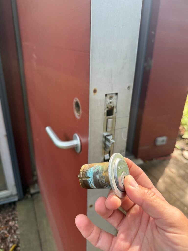 Removed long mortise cylinder beside an extra-thick door on Calves Neck Road in Southold