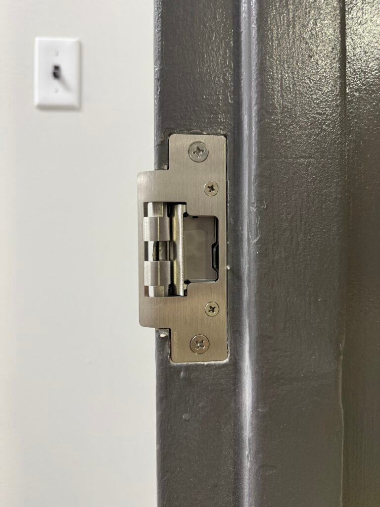 Electric strike fitted into a metal door frame on Roanoke Avenue in Riverhead